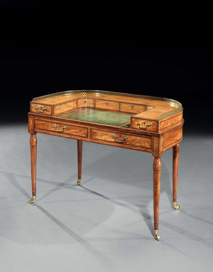 A George III small satinwood Carlton house writing table attributed to Gillows